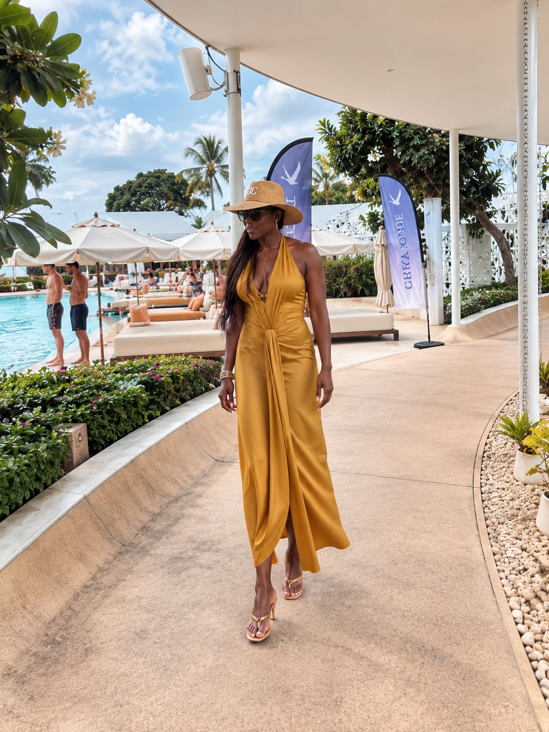 Vanessa in a mustard-gold dress beside a resort pool in Koh Samui, Thailand